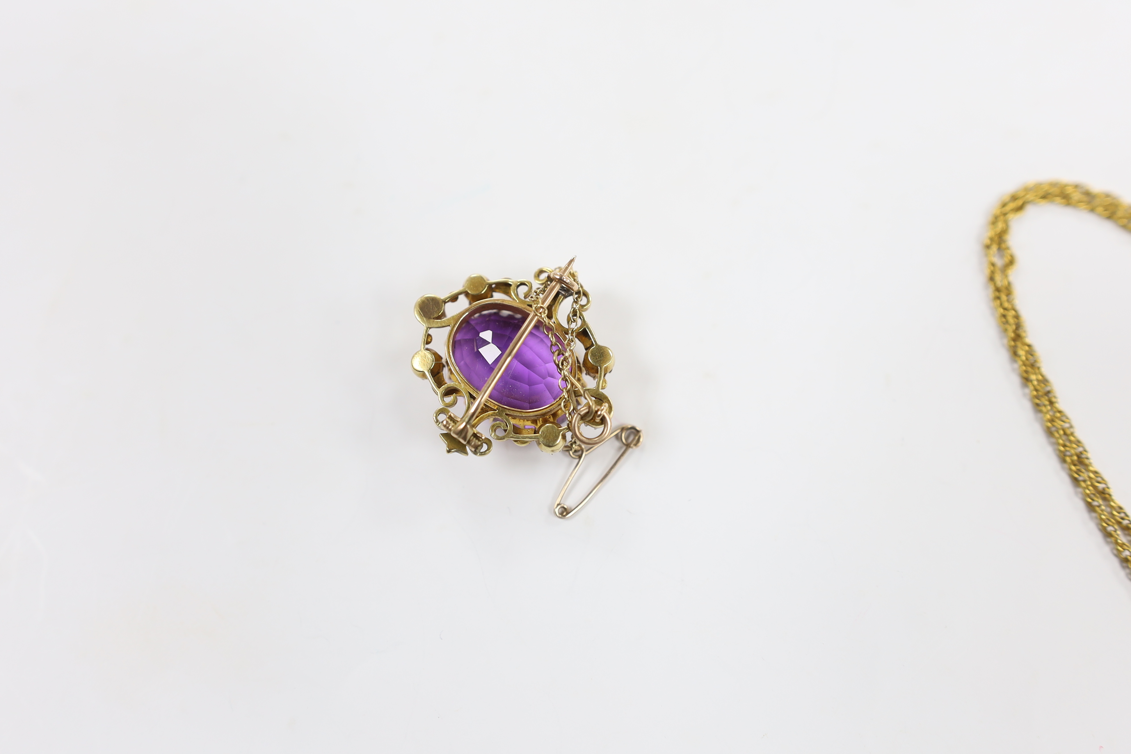 A 1960's 9ct gold, amethyst, seed pearl and diamond chip set drop pendant, 35mm, on a 9ct gold chain, 40cm and a yellow metal, amethyst and seed pearl set oval brooch, gross weight 16.5 grams.